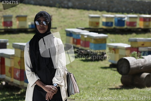 Image of african muslim businesswoman portrait on small local honey production farm