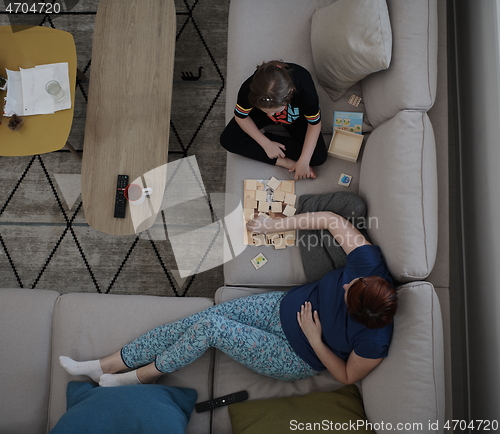 Image of mother and daughter at home playing memory game