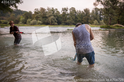 Image of young men having fun with water guns