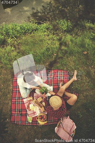 Image of top view of couple enjoying picnic time