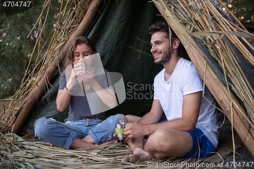 Image of couple spending time together in straw tent