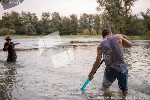 Image of young men having fun with water guns