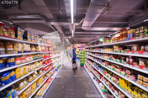 Image of Man shopping in modern supermarket