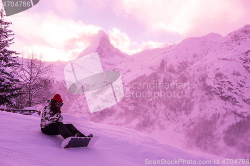 Image of rescue team with a red helicopter rescuing a hurt skier