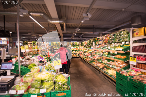 Image of people shopping in modern supermarket