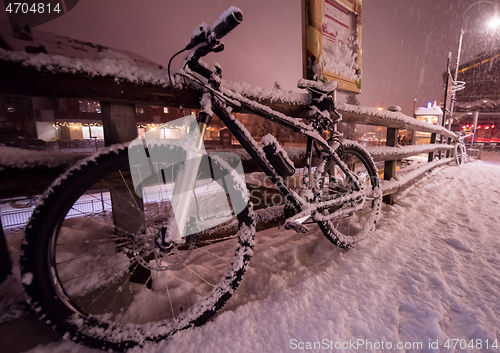 Image of parked bicycle covered by snow