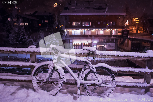 Image of parked bicycle covered by snow