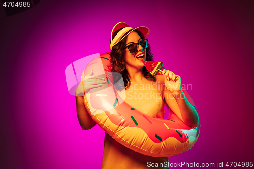 Image of Happy young woman standing and smiling against pink background