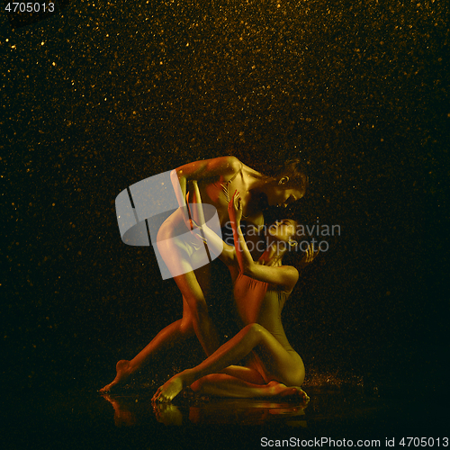 Image of Two young female ballet dancers under water drops