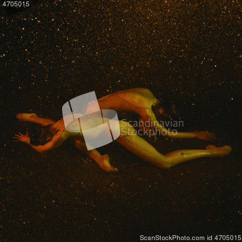 Image of Two young female ballet dancers under water drops