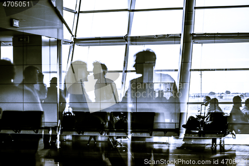 Image of Silhouettes of business people traveling on airport waiting at the plane boarding gates