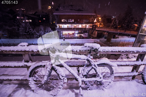 Image of parked bicycle covered by snow