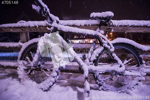 Image of parked bicycle covered by snow