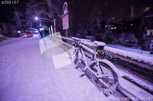 Image of parked bicycle covered by snow