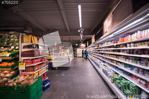 Image of people shopping in modern supermarket