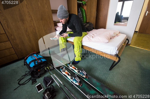 Image of skier preparing ski accessories