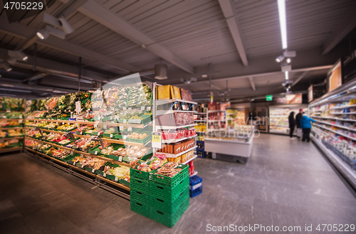 Image of people shopping in modern supermarket