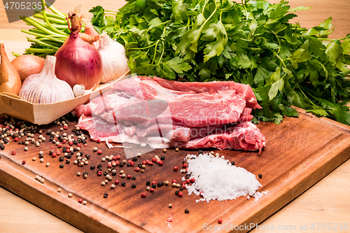 Image of Raw pork ribs in the loin on a wooden board