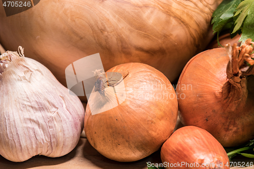 Image of garlic onion shallot parsley with pestle and olive wood mortar