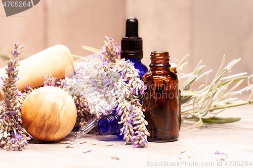 Image of lavender mortar and pestle and bottles of essential oils for aro