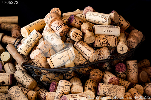 Image of old cork stoppers of French wines in a wire basket