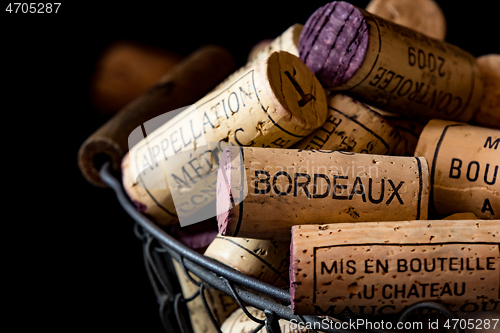 Image of old cork stoppers of French wines in a wire basket