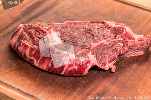 Image of steak of beef on a wooden board