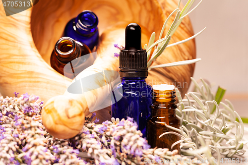 Image of lavender mortar and pestle and bottles of essential oils for aro