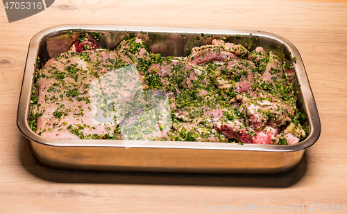 Image of raw meats marinated in garlic olive oil parsley salt pepper