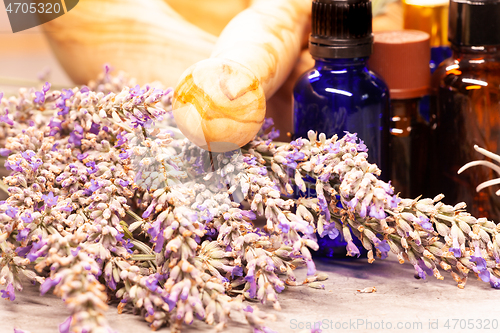 Image of lavender mortar and pestle and bottles of essential oils for aro