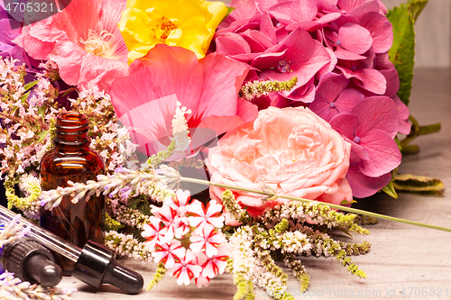 Image of flowers and bottles of essential oils for aromatherapy