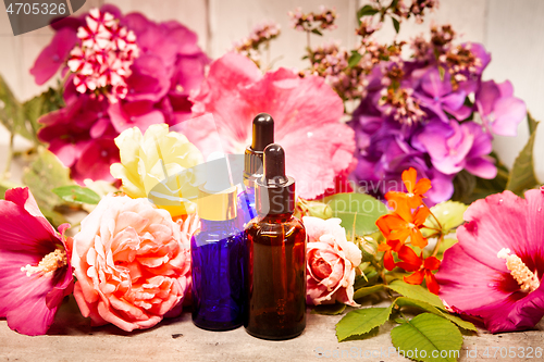 Image of flowers and bottles of essential oils for aromatherapy