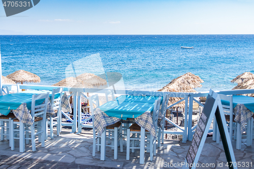 Image of restaurant terrace in front of the beach in kamari on the island