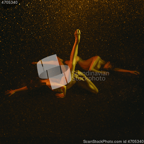 Image of Two young female ballet dancers under water drops