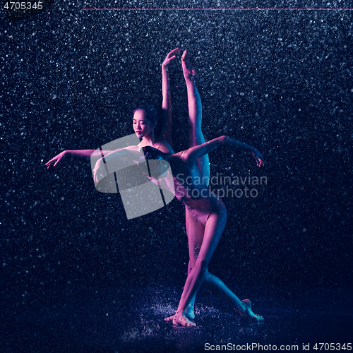 Image of Two young female ballet dancers under water drops