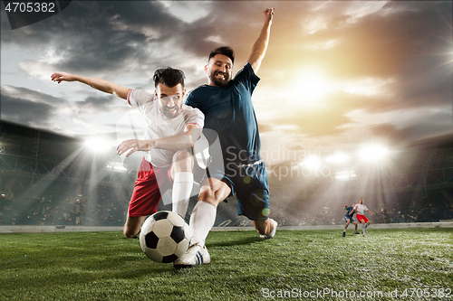 Image of Two men are playing soccer and they compete with each other