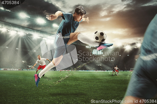 Image of Two men are playing soccer and they compete with each other