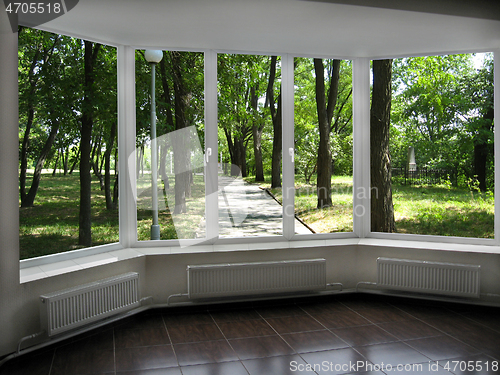 Image of window with view of summer city park