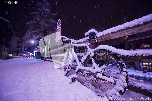 Image of parked bicycle covered by snow