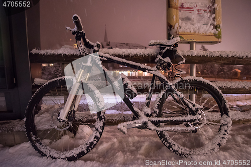 Image of parked bicycle covered by snow