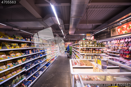 Image of Man shopping in modern supermarket