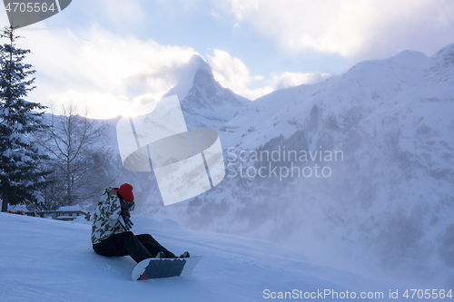 Image of rescue team with a red helicopter rescuing a hurt skier