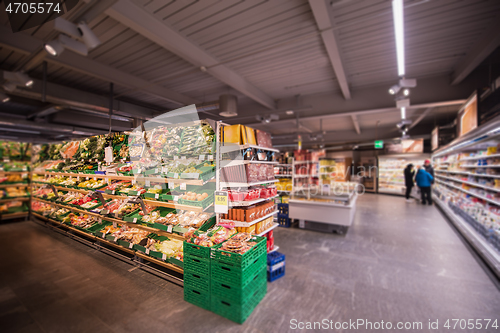 Image of people shopping in modern supermarket