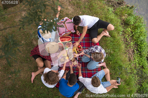 Image of top view of group friends enjoying picnic time