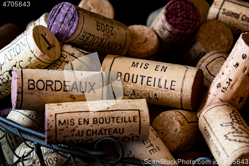 Image of old cork stoppers of French wines in a wire basket