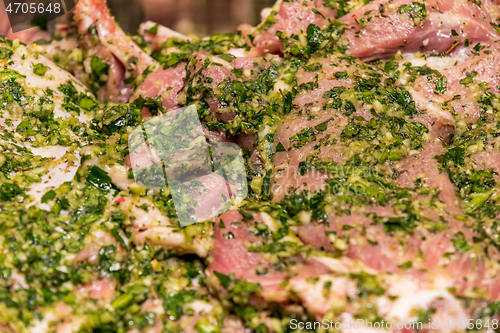 Image of raw meats marinated in garlic olive oil parsley salt pepper