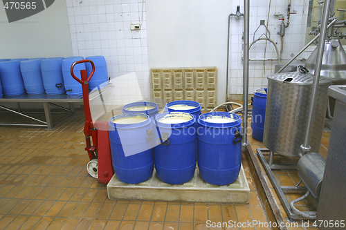 Image of pallet truck with raw processed cheese in dairy