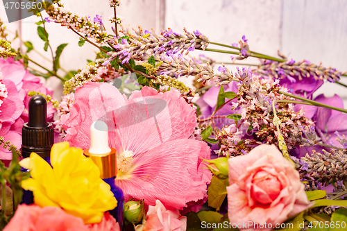 Image of flowers and bottles of essential oils for aromatherapy