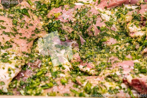 Image of raw meats marinated in garlic olive oil parsley salt pepper