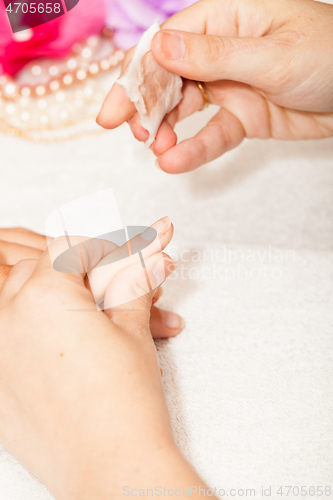 Image of Manicure of nails from a woman\'s hands before applying nail poli